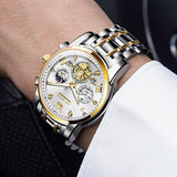 Luxury wristwatch with silver and gold band on a person's wrist.